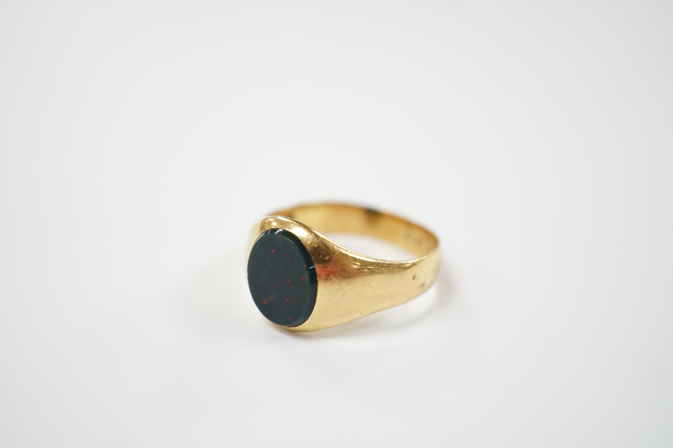 An 18ct gold and single stone oval bloodstone set signet ring, size Z+++++